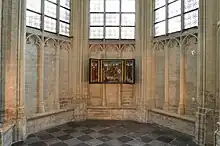 Triptych on the interior northwest stone wall of the apse chapel of Saint Peter's Church in Leuven, Belgium, from 2012.