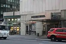 The main entrance on Lexington Avenue, which consists of a set of metal doors on either side of a revolving door