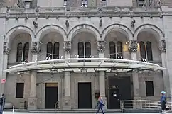 The hotel's main entrance, a set of five arches, with a metal-and-glass canopy above them