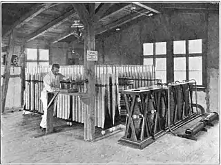 Telefunken 25 kW long distance transmitter built 1906 at Nauen Transmitter Station, Nauen, Germany, showing large 360 Leyden jar 400 μF capacitor bank (rear) and vertical spark gaps (right)