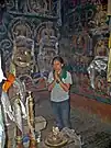 Young woman making offerings. Lhalung Gompa. 2004.