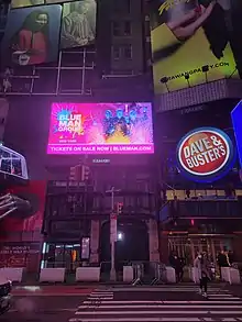 The entrance of the Liberty Theatre as seen from across 42nd Street. There are multiple signs and billboards surrounding the entrance, including a Dave & Buster's sign to the right.