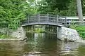 The arched Lily Pond Foot Bridge crosses its inlet on Brantingham Lake, New York