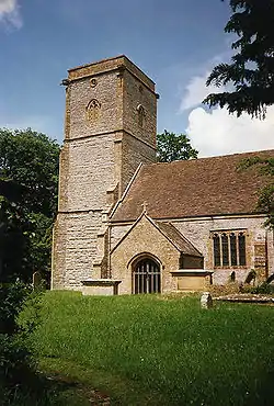 Stone building with square tower.