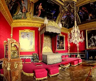 Lit de parade, Salon of Mercury.  The clock, by Antoine Morand, was offered to Louis XIV in 1706.  It is the only piece of furniture from the Grand Appartement that has survived, however the original Boulle marquetry case has been replaced.