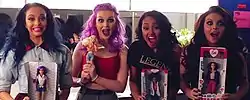 Little Mix pose holding dolls.