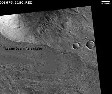 Lobate debris apron in Phlegra Montes, as seen by HiRISE.  The debris apron is probably mostly ice with a thin covering of rock debris, so it could be a source of water for future Martian colonists.  Image from the Cebrenia quadrangle.  Scale bar is 500 meters long.