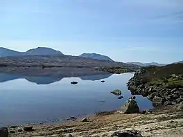 An upland lake with hills in the distance