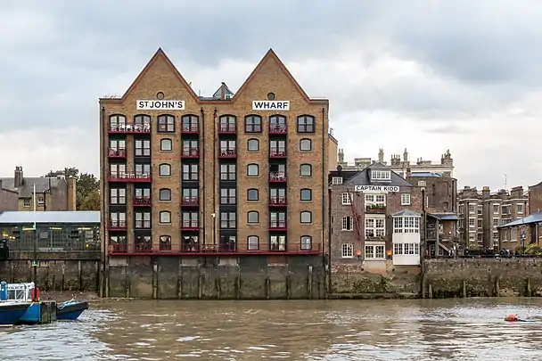 Wapping: warehouses—now flats and a pub—built on the wall