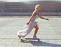 A skater riding her pintail longboard