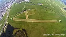 Photograph of the airport runway surrounded by a grassy area