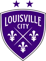 A three-sided purple shield logo with a white outline. Each of the three edges is curved, and the top edge is shorter than the left and right edges. It reads "LOUISVILLE" in large subtly-serifed white lettering that forms an arch along the top of the shield. Just below it reads "CITY" in slightly-smaller non-arched lettering. The center and bottom of the shield is occupied by two fine lines forming an X, with three fleur-de-lis symbols to the left, right, and bottom of the X. The fleur-de-lis symbols are bold and somewhat angular; in particular, the central pedal comes to a point at the top. Above the shield are two purple stars symbolizing the team's two championships.