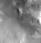 Lyot Crater Channel, as seen by CTX.  Water-carved channels have been spotted in Lyot Crater; the curved line may be one.  Click on image for a better view.