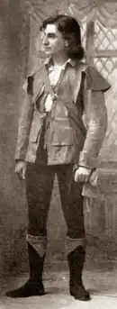 Young, clean-shaven white man with longish dark hair, in medieval costume