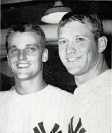 Two men in pinstripe baseball uniform with an interlocking "NY" partially showing at the bottom.