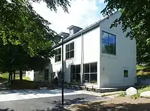 Modern, white two-storey building with large windows