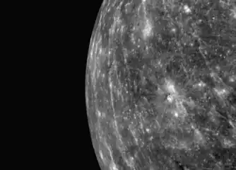 View of Mercury's limb at a high sun angle, with Warhol as the bright crater near center