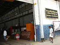 Doorway of a large building, with two men for scale