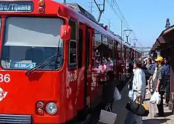 Riders boarding an original Siemens–Duewag U2 Blue Line train at Old Town Transit Center (March 2008)