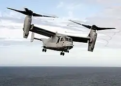 The MV-22 Osprey tiltrotor has a high disk loading, producing visible blade tip vortices.