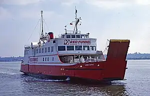  Three-quarter view of ship, with red hull and white superstructure, steaming left to right