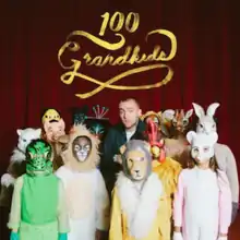 The cover features Mac Miller surrounded by children dressed in costumes with a red curtain behind them. The song's title is above them, written in gold cursive text.