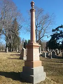 Red granite pillar inscribed with names