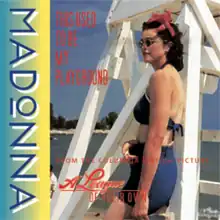 Madonna wearing sunglasses and beachwear, while standing in front of a white lifeguard tower.