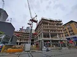 Seven floors of the buildings under construction with a large crane labeled "MAESTRIA" alongside.