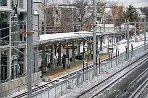 A nearly-complete light rail station next to a railway line