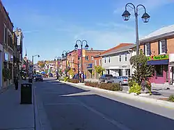 Village street with buildings and lamp posts