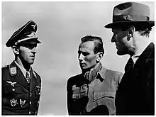 The head and shoulders of a man, shown in semi-profile. He wears a military uniform with various military decorations and an Iron Cross at the front of his shirt collar.