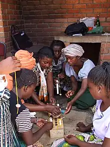 Image 9Mbawemi Women's group in Malawi learning how to add value to beeswax by making candles (from Malawi)