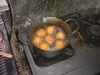 A batch of sata andagi being deep fried