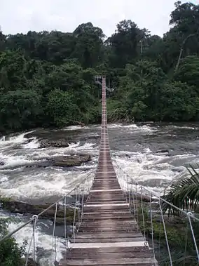 Wooden suspension bridge over a river.