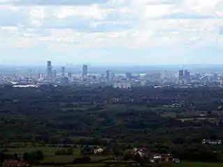 View of Manchester from Hartshead Pike, 8 miles (13 km) away with Fiddlers Ferry Power Station beyond,  27 miles (43 km) away.