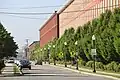 A view of all three mill buildings, looking north on Riverside Avenue. May 2023.