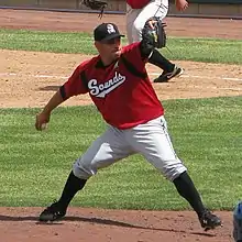 A baseball player in red and gray