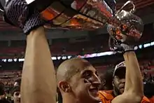 Marco Iannuzzi hoists 99th Grey Cup.