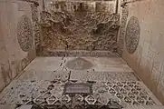 View from below of the stonework inlay, reliefs, and muqarnas vault in the portal