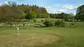 Golf course with hills in background