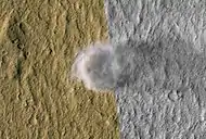 A dust devil on hilly terrain in the Amazonis region.