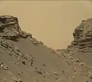 View from Mastcam on Curiosity showing sloping buttes and layered outcrops on lower Mount Sharp