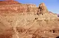 Marsh Butte (end of ridge) formed in Redwall Limestone. Tapeats Sandstone (brown cliff at bottom of photograph), Manakacha Formation (red cliff at top of photograph).