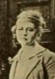 A young white woman with light-colored hair, wearing a light-colored jacket