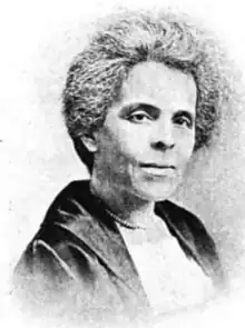 Mary Elizabeth Jackson, a middle-aged Black woman with greying hair and light skin, wearing a dark jacket over a light top