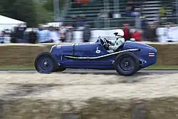 Bira's 1936 Maserati 8CM, seen in his original all blue livery with Siamese flags on the tail and the White Mouse emblem just ahead of the cockpit