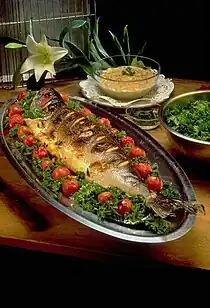 Image 26Masghouf fish, one of Iraq's national dishes, a Mesopotamian cuisine dating back to ancient times, typically fish caught from the rivers of Euphrates and Tigris, and grilled near the river bed (from Culture of Iraq)