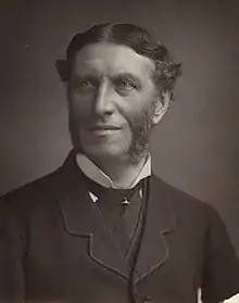 Monochrome photograph of the poet Matthew Arnold with centre parting and sideburns