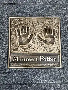 Bronze cast of hand prints and the name Maureen Potter